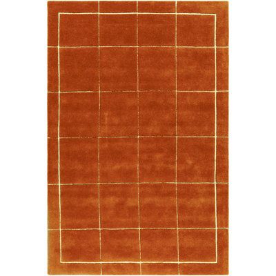 an orange rug with squares on it