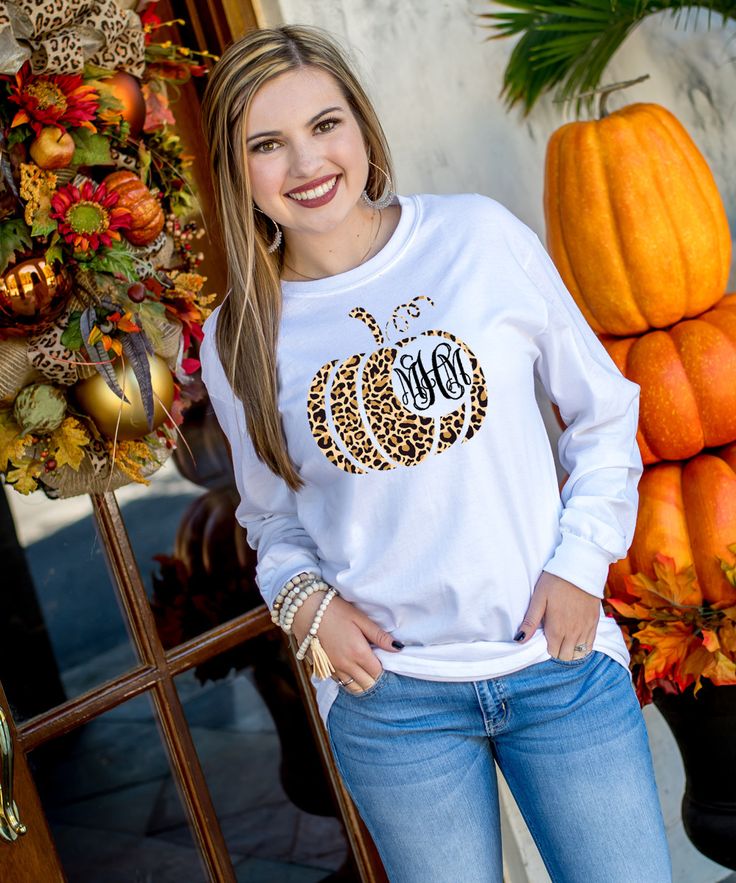 We are in love with this monogrammed leopard pumpkin graphic t-shirt! Make it your own by choosing from a t-shirt, v-neck t-shirt, long sleeve, tank top, or even a sweatshirt! We also offer your favorite brands Gildan, Bella Canvas or Comfort Colors! The options are endless!    break:specs  GILDAN Short Sleeve - 6.0 oz. pre-shrunk 100% cotton Long Sleeve - 6.0 oz. pre-shrunk 100% cotton V-Neck - 4.5 oz. pre-shrunk 100% ring spun cotton Tank Top - 5.3 oz. pre-shrunk 100% cotton Sweatshirt - 8 oz Fall Monogram Shirt, Fall Leopard Print Tops With Letter Design, Fall Leopard Print Top With Letter Details, Fall Leopard Print Cotton Tops, Leopard Print Cotton Tops For Fall, Fall Leopard Print Graphic T-shirt, Fall Monograms, Pumpkin Graphic, Monogram Shirt