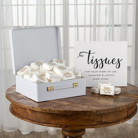 a white box filled with soaps sitting on top of a wooden table next to a sign