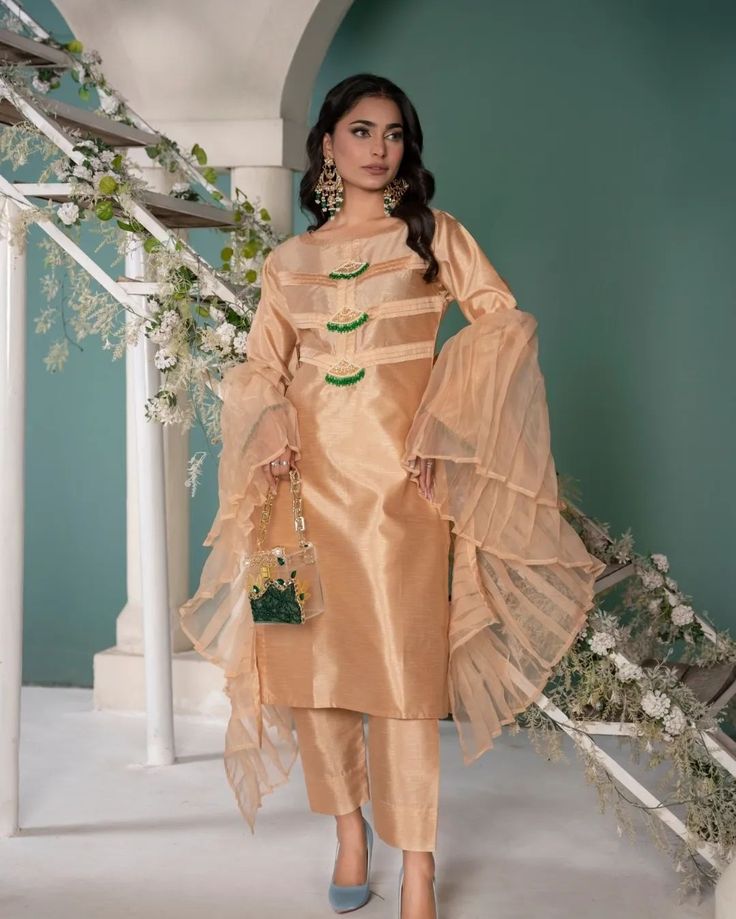 Step up your Eid fashion game with the SEHR 3 piece shirt. Made with high-quality raw silk, this shirt features stunning pleats on the neckline and beautiful handmade motifs with green and gold pearl embellishments on the sleeves. Complete the look with the organza statement dupatta for a designer touch.   #readytowear #Pakistaniwedding #Pakistanibride #ModernPakistaniFashion #UKFashion #PakistaniStyle #FashionInLondon #UKDesiStyle #ContemporaryPakistani #Pakistanicasualwearuk #LondonFashio... Statement Dupatta, Pakistani Casual Wear, Fashion In London, Eid Fashion, Eid Outfit, Pakistani Outfits, Uk Fashion, Pakistani Fashion, Raw Silk