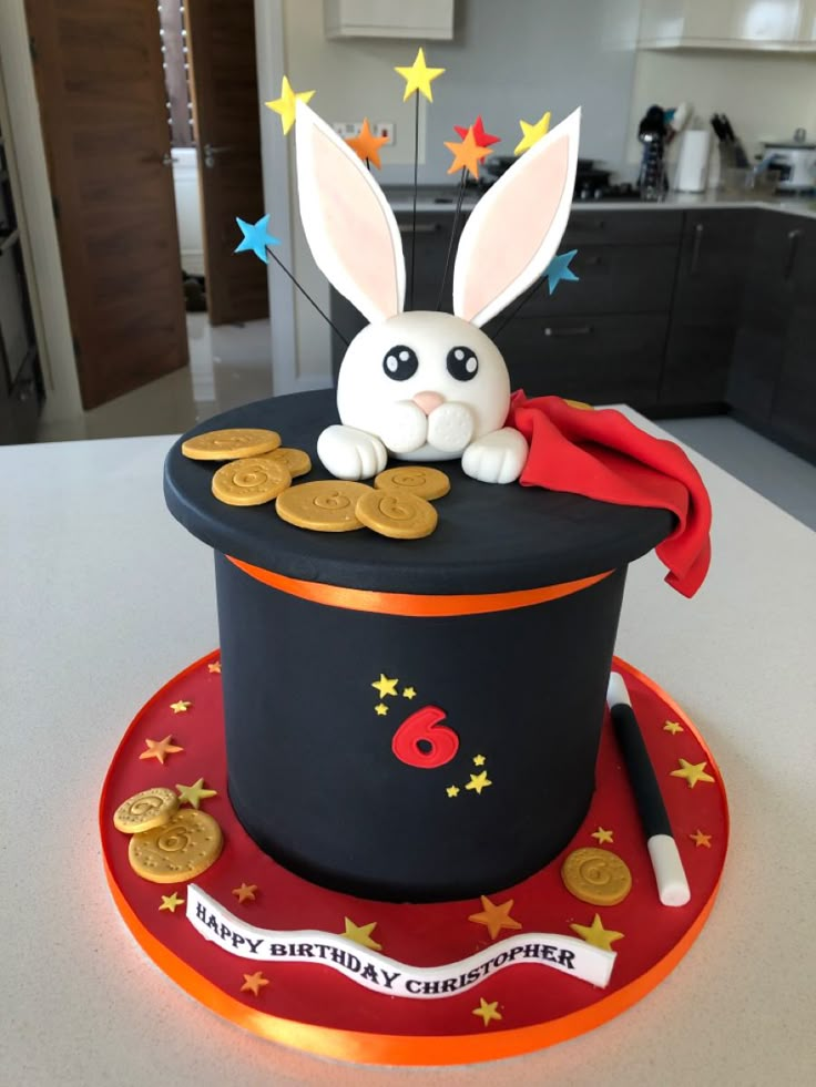 a birthday cake with a rabbit in a top hat and gold coins on the table