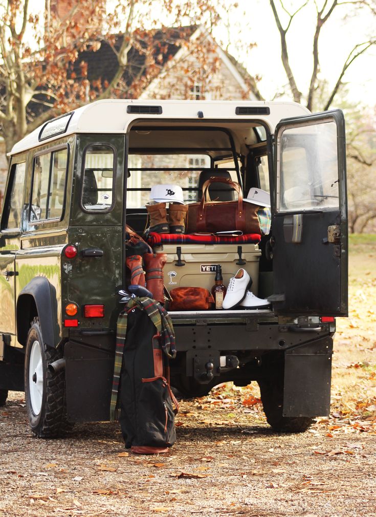 the back end of a vehicle filled with luggage