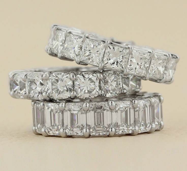 three diamond rings stacked on top of each other with the middle one being surrounded by smaller diamonds