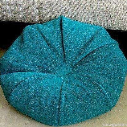 a blue bean bag sitting on top of a floor