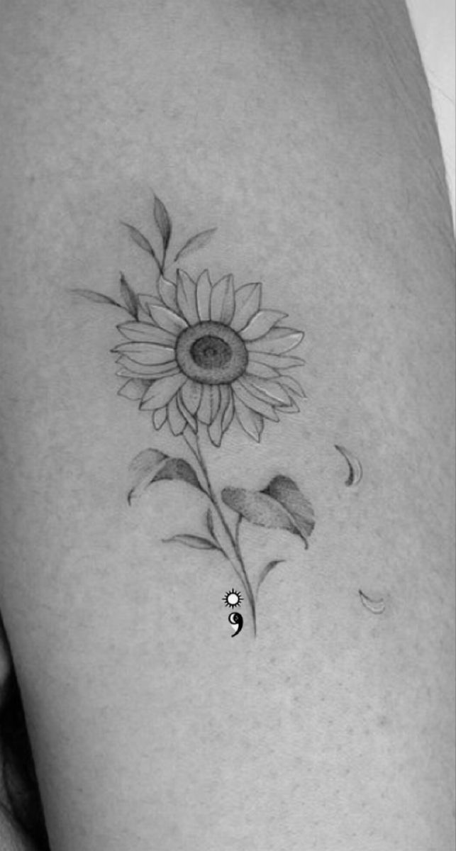 a sunflower tattoo on the left thigh