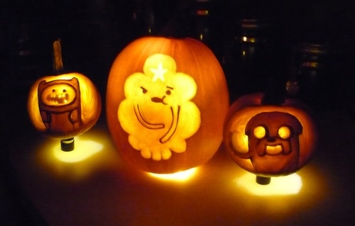 three carved pumpkins with faces on them