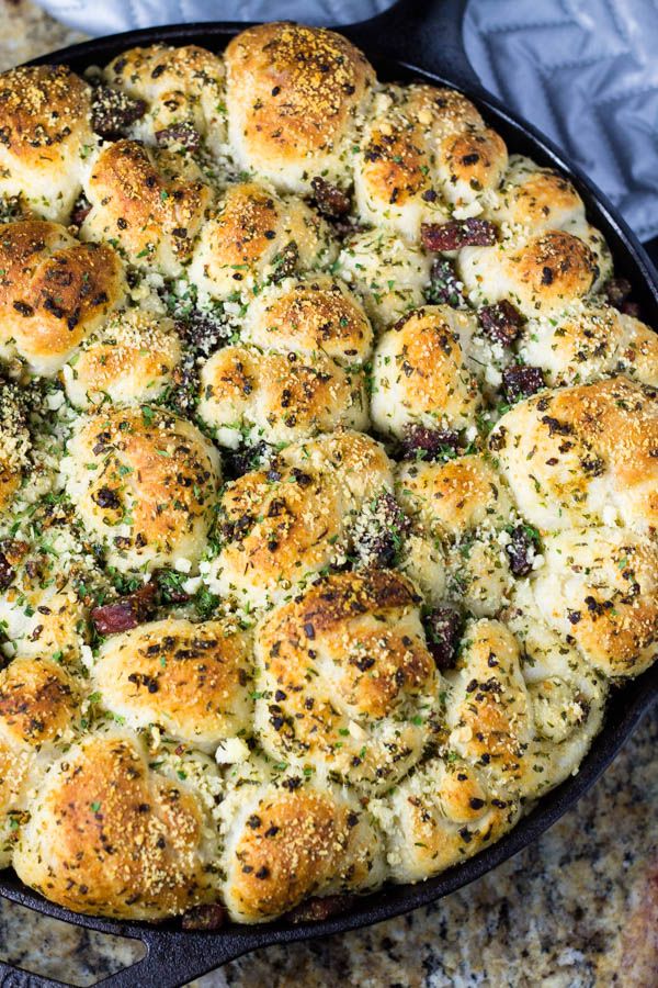 a skillet filled with bread and cheese on top of a table