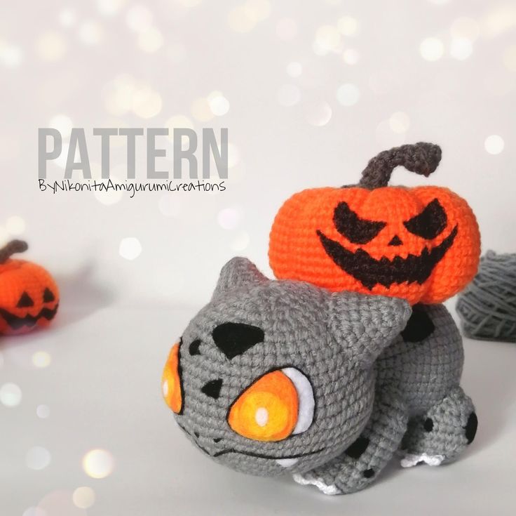 a crocheted gray cat with a pumpkin on its head