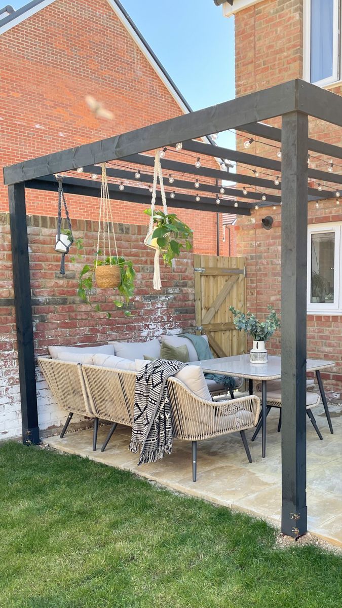 an outdoor dining area with patio furniture and potted plants