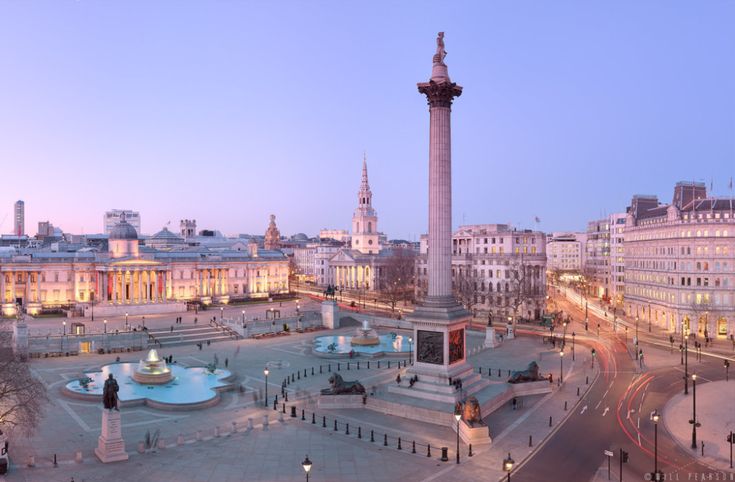 an aerial view of a city square at dusk