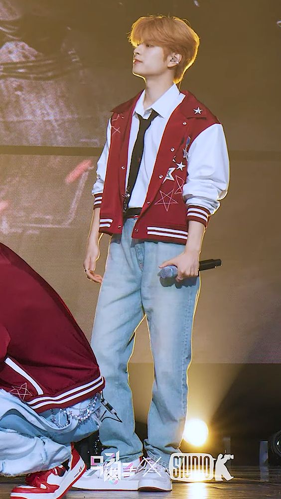 a young man standing on top of a stage