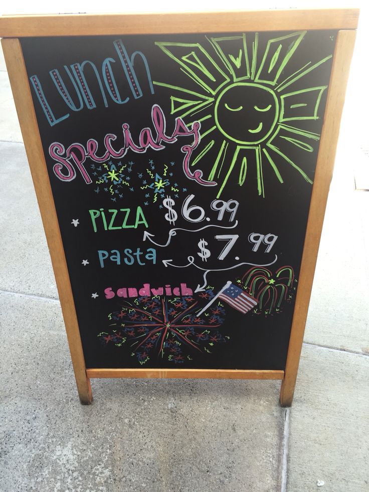 a chalkboard sign advertising lunch specials on the sidewalk