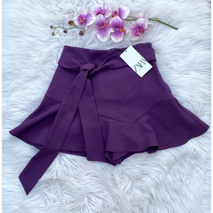 -New With Tags -Zara Purple Ruffle Mini Skort -Size: X-Small -Color: Purple -Mini Skirt With Shorts Inside -Ruffle Hem -Bow Sash On Front Ties At Hip -Waist Laid Flat Measures 12.5” -Measures 15” Long -90% Polyester, 10% Elastane *This Beautiful Skort Is Perfect For Holiday Parties Or Date Nights! Gives You The Flirty Look Of A Mini Skirt And The Functionality Of Shorts Hidden Underneath! Chic Purple Bottoms For Day Out, Purple Short Bottoms For Party, Purple Short Length Bottoms For Party, Purple Party Bottoms Short Length, Elegant Ruffled Fitted Shorts, Purple Short-length Party Bottoms, Purple Short Length Party Bottoms, Zara Ruffled Party Bottoms, Chic Stretch Purple Bottoms