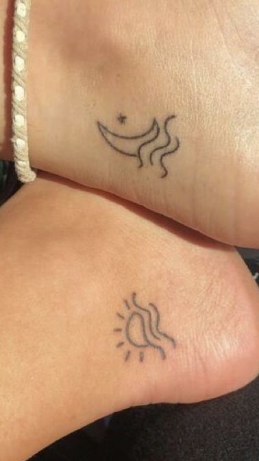 two people with matching tattoos on their feet, one has a sun and the other has a moon