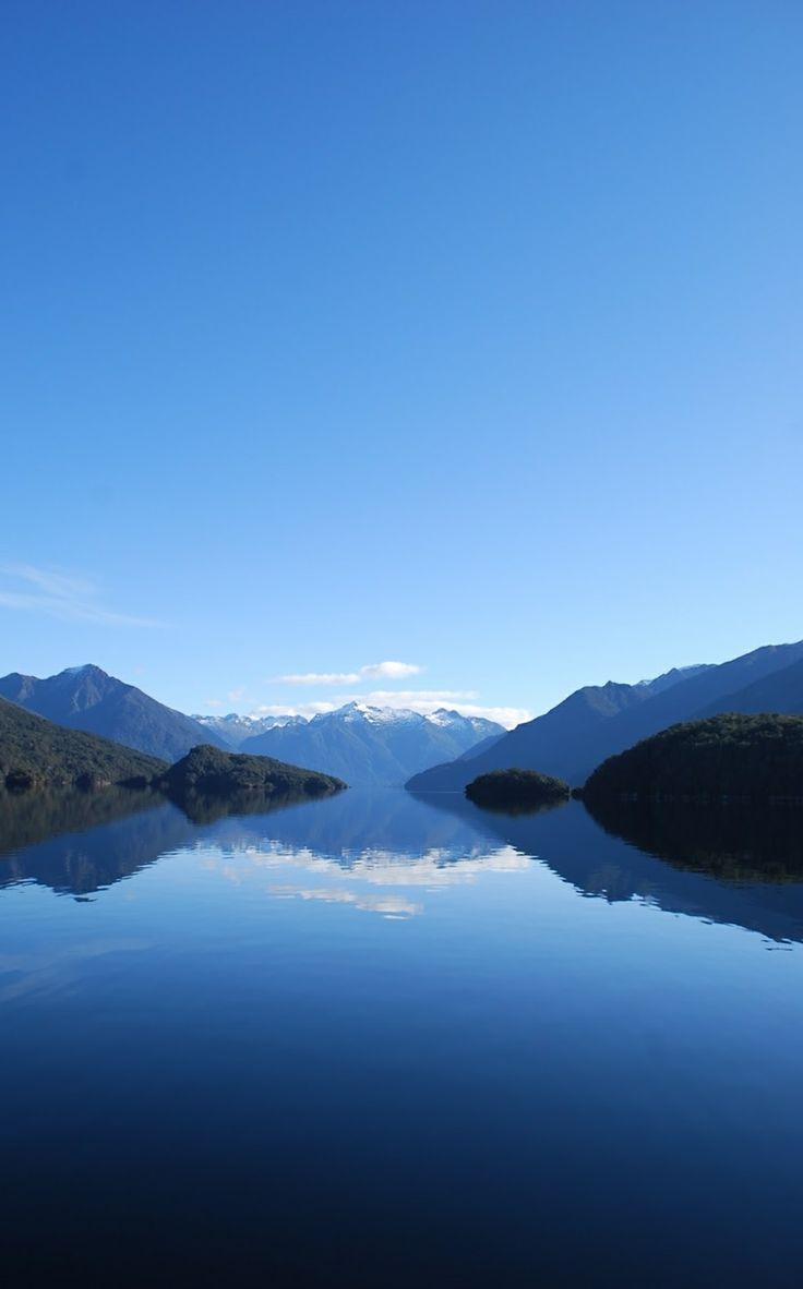 a lake with mountains in the background