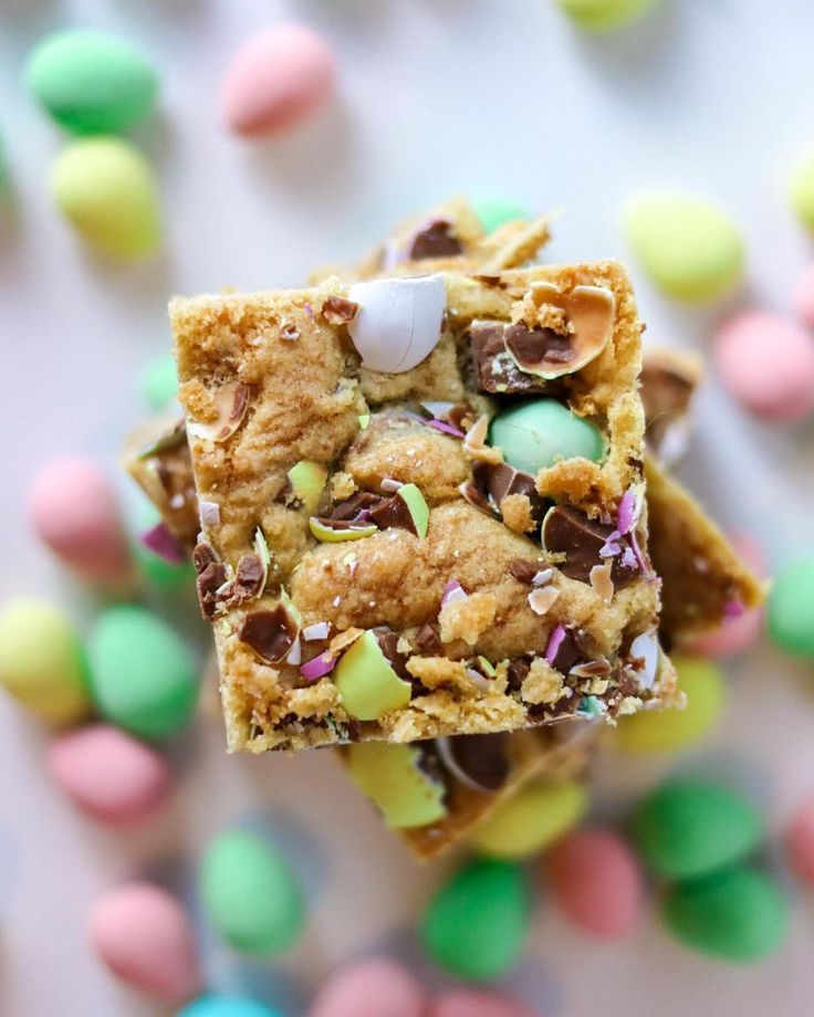 a close up of a piece of food on a table with candy and candies