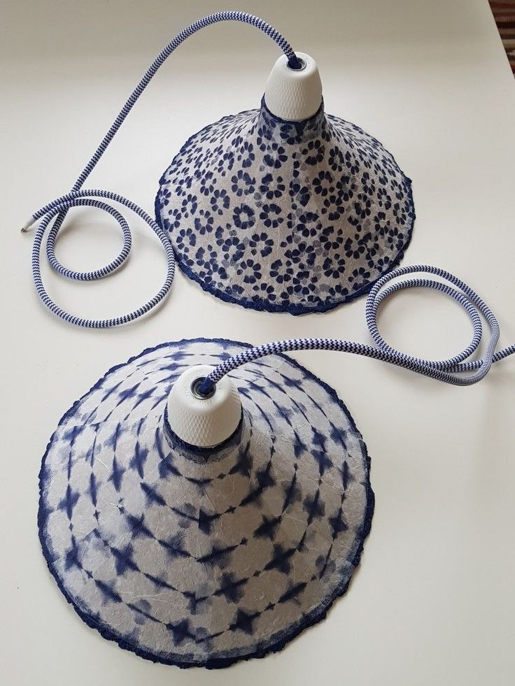 two blue and white lamps sitting on top of a table