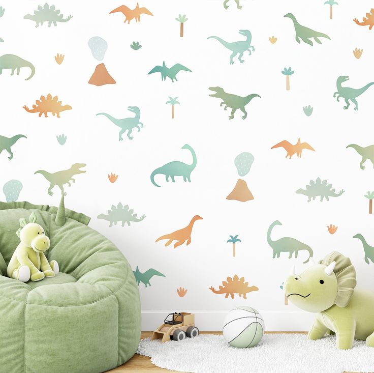 a child's room with dinosaur wallpaper and toys on the floor in front of it