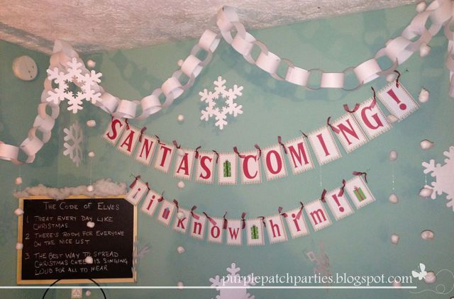 a bulletin board with snowflakes hanging from it's sides and writing on the wall