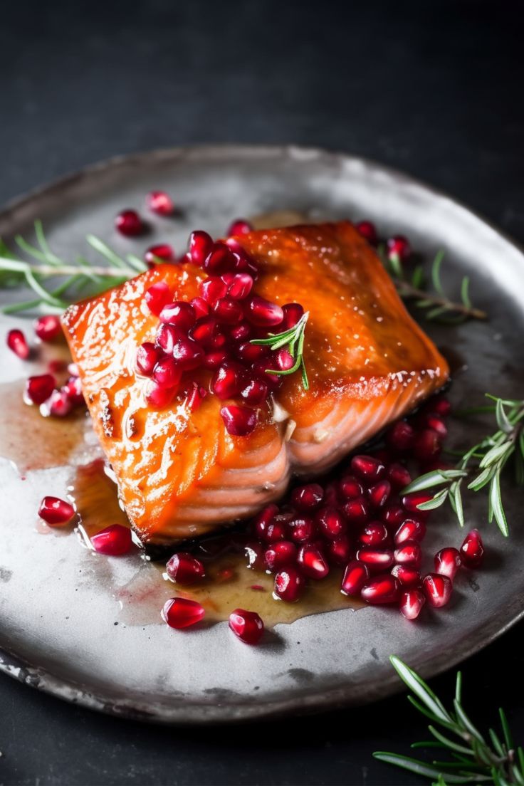 salmon with pomegranate and herbs on a silver plate, ready to be eaten