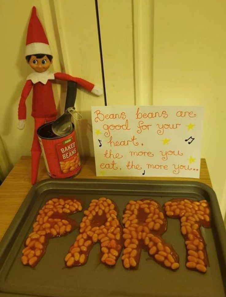 an elf is standing next to a pan with peanuts on it