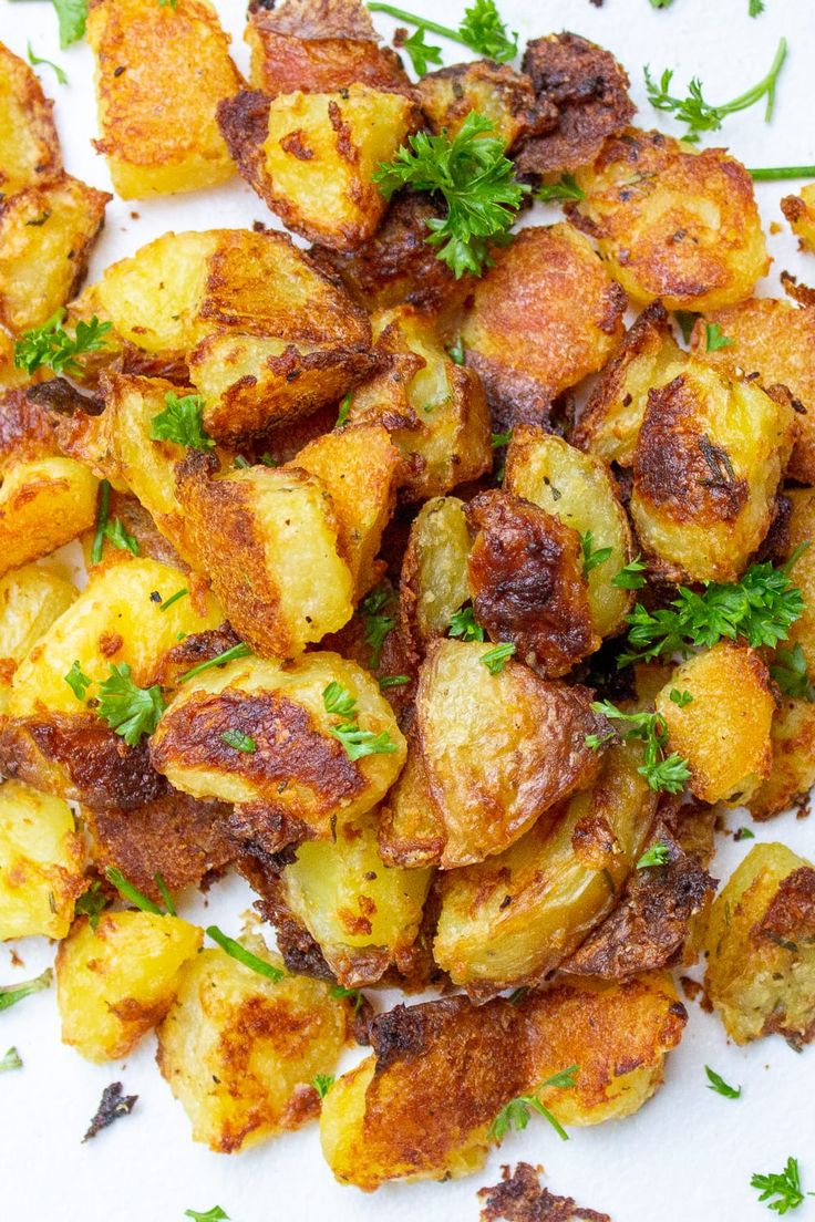 roasted potatoes with parsley on top are ready to be eaten for lunch or dinner