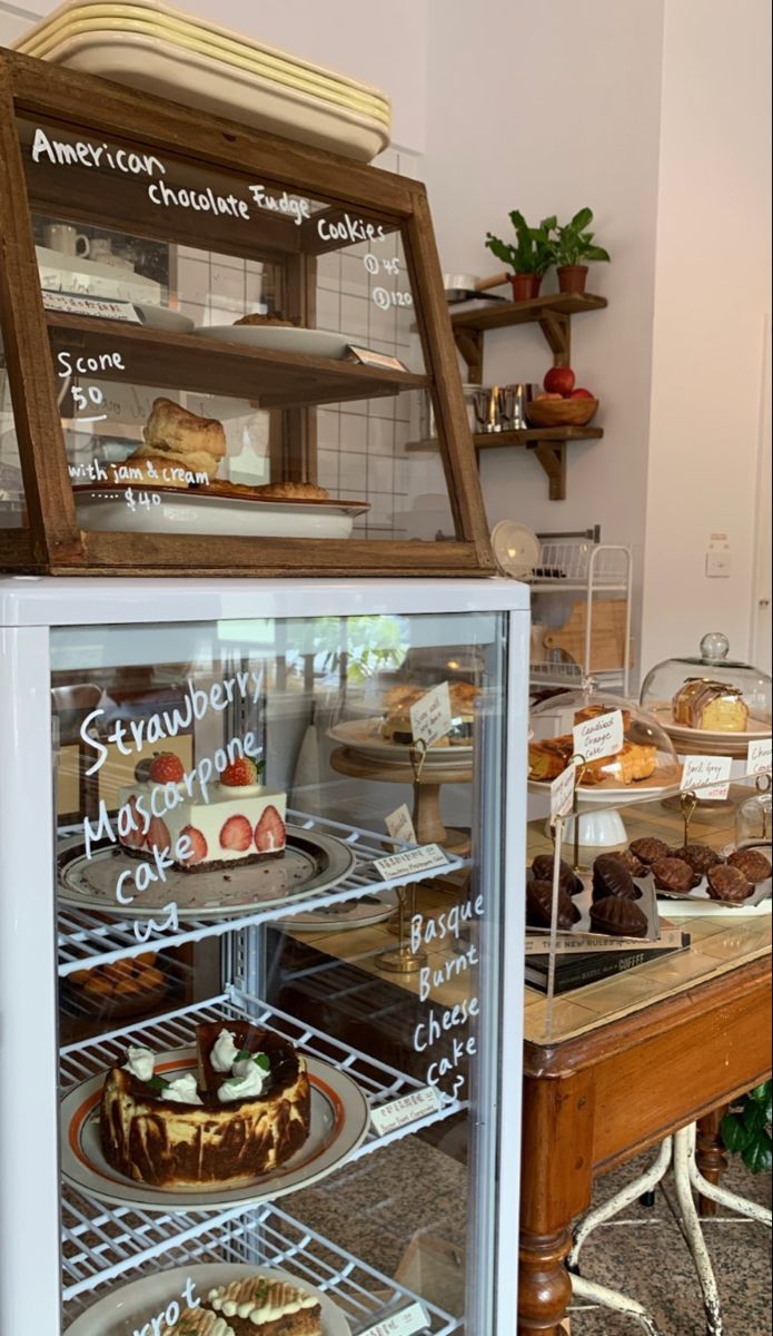 a display case filled with cakes and pastries