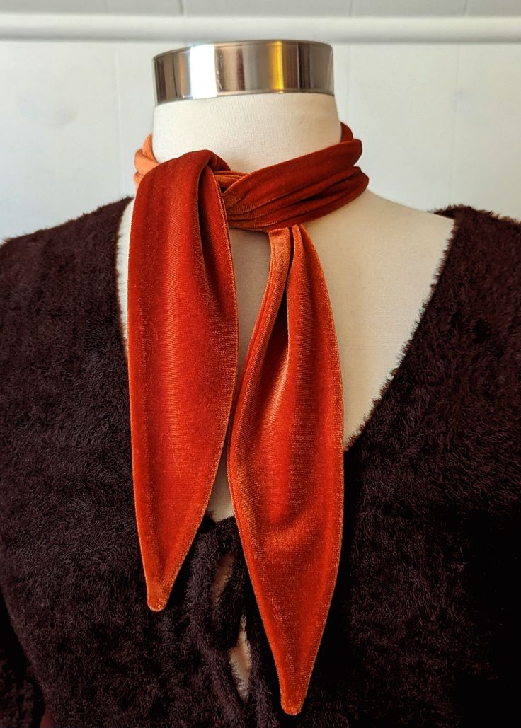 All accessories are final sale Add a lil rock and roll to your 'fit with this dreamy velvet scarf tie. Made from plush stretch velvet in a burnt orange colorway. Wear it tied around your neck, as a headband, as a hat band, tied around a belt loop, whatever ya like! Features: Scarf tie Stretch plush velvet Burnt orange colorway Handmade in LA Brand & Fabric Content: Brand: I'm With the BandMaterials: stretch velvet Made in: Los Angeles, CA Approx. measurements: Approx. 33" long and 2.5" wide when