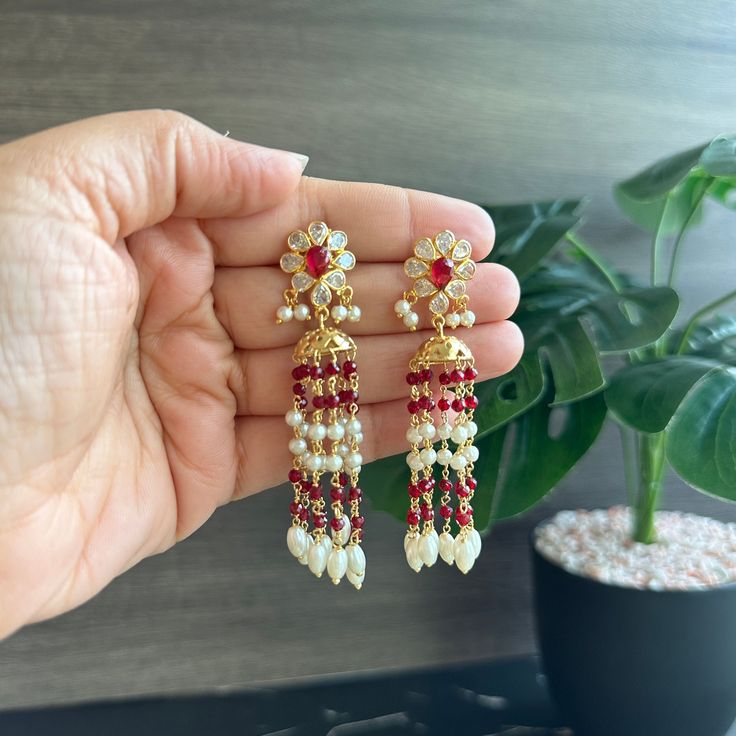 14k Gold plated Ruby white Pearl Temple earringsf. Light weight . Shipping is 2-3 days and delivery is 4-5 days . brass material is used . Dangle Latkans Earrings For Puja, Temple Jewelry Kundan Jhumkas For Pierced Ears, Latkan Dangle Earrings For Puja, White Latkans Earrings For Navratri, White Chandbali Earrings For Navratri, Traditional White Jhumkas For Pierced Ears, White Drop Earrings Jhumkas For Diwali, White Temple Jewelry Jhumkas For Eid, White Drop Jhumkas For Diwali