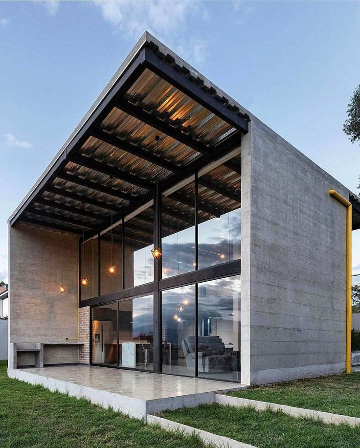 the modern house is made out of concrete and glass