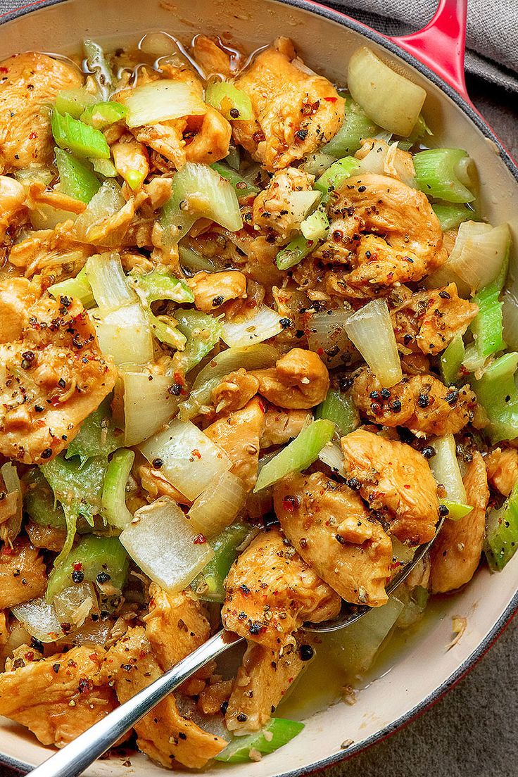 a bowl filled with chicken, onions and celery