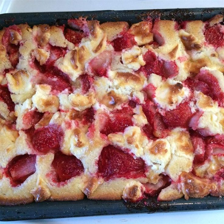 a baking dish with strawberries and cream cheese