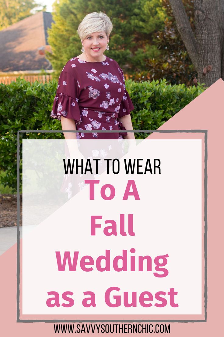 a woman standing in front of a tree with the words what to wear to a fall wedding as a guest