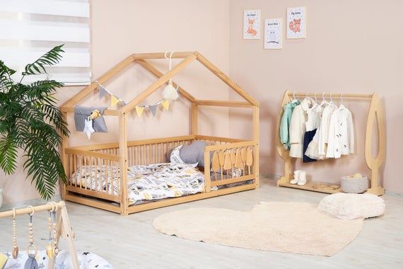 a baby's room with pink walls and white floors