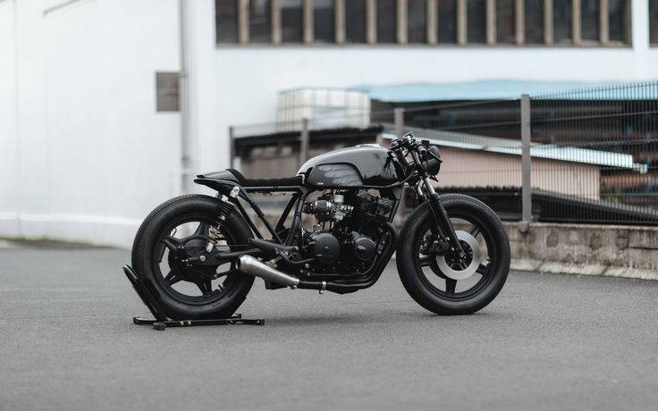 a black motorcycle parked in front of a building