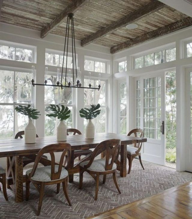 the dining room table is surrounded by chairs and vases with plants in them on either side