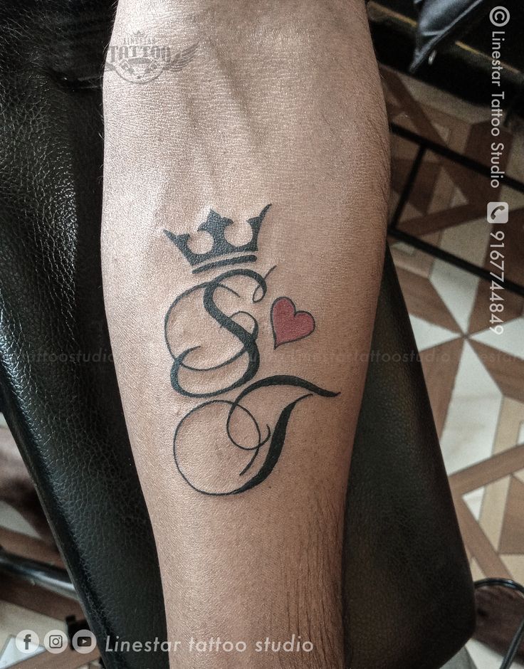 a person with a tattoo on their leg and a crown in the shape of a heart