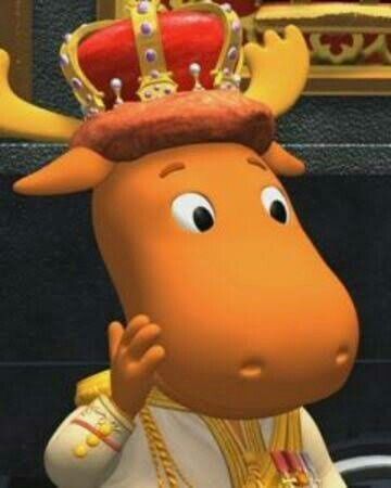 a cartoon moose with a crown on his head sitting in front of a wall and looking at the camera