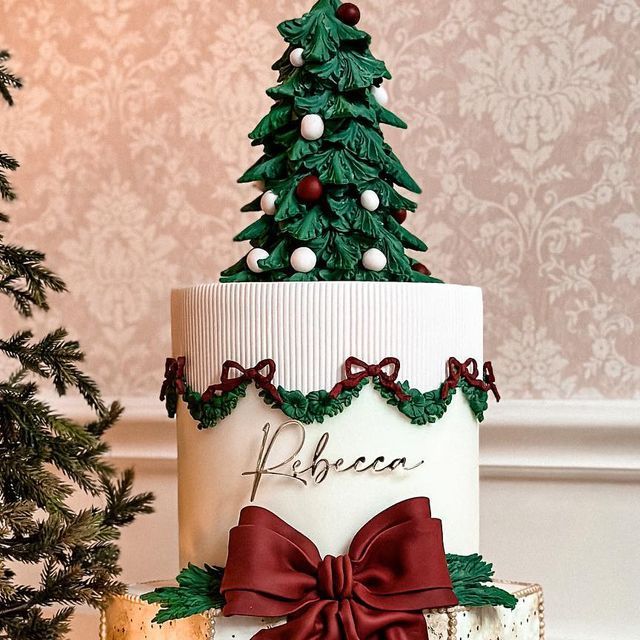 a decorated christmas cake with a tree on top