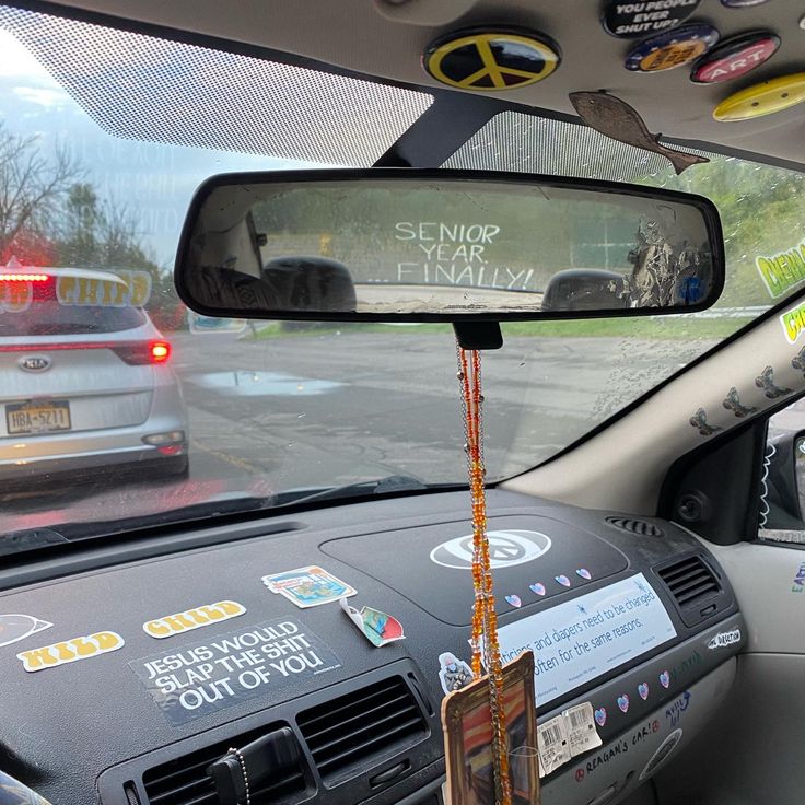 there is a car that has been decorated with stickers on the dashboard and in the passenger seat