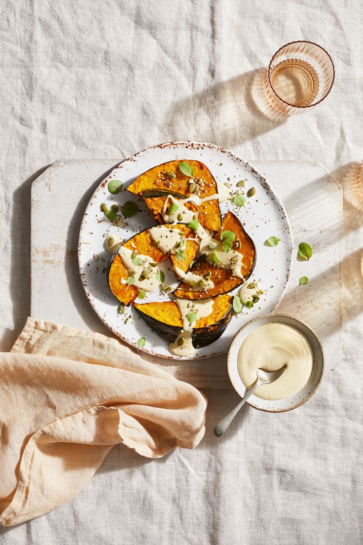 a white plate topped with squash covered in cheese