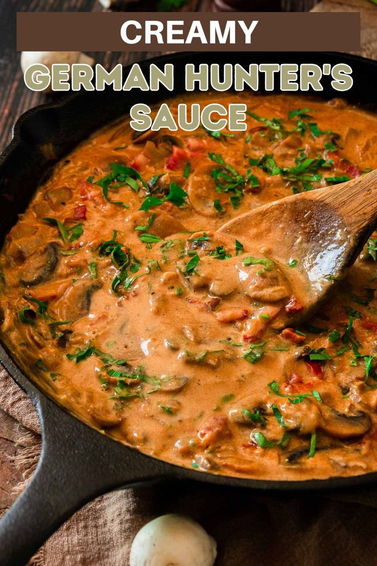 creamy german hunter's sauce in a skillet with a wooden spoon