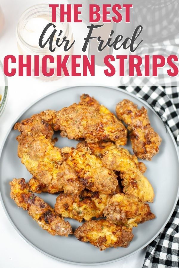 the best air fried chicken strips on a white plate with black and white checkered table cloth