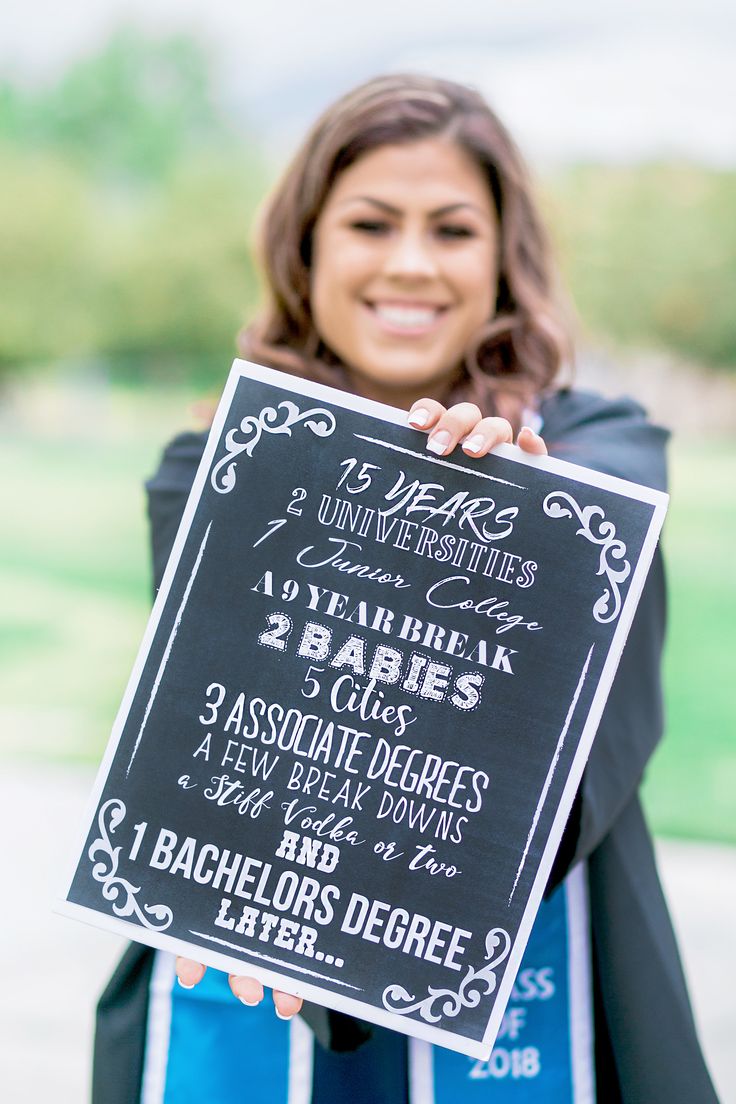 a woman holding up a chalkboard sign for an event