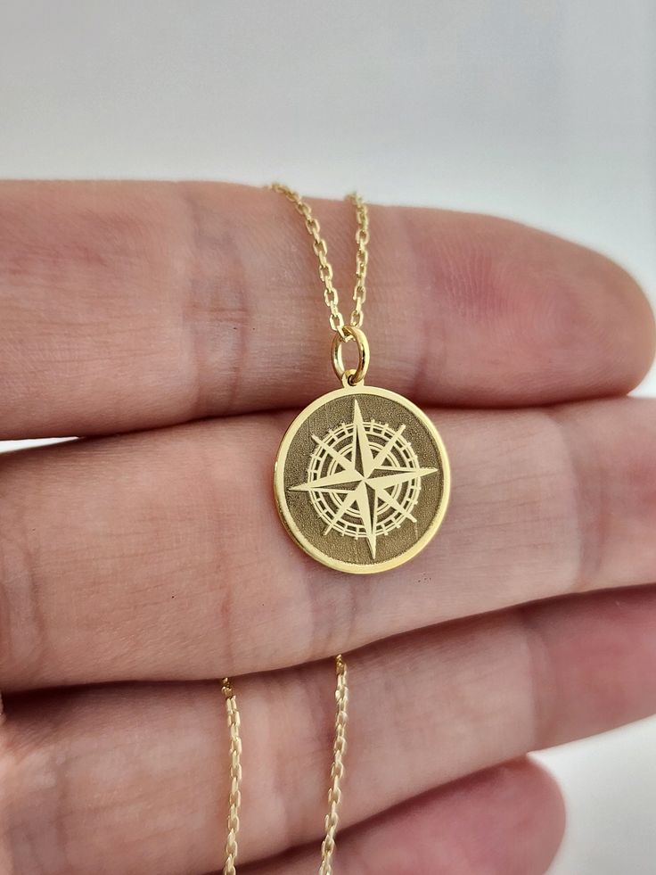 14K Solid Gold Compass Necklace, Personalized Compass Charm, Traveler Gift Pendant, Gold Disc Compass Jewelry, Navigation Compass Pendant 14 Material of pendant: Solid gold 14k ♣ Metal Stamp: 14k ♣The pendant is available in 3 sizes: 12.7 / 0,50 inches ( Diameter ) 15.2 mm / 0,60 inches ( Diameter ) 19,1 mm / 0,75 inches ( Diameter ) ( In the photos the size of the pendant is 15mm / 0.55 inches Diameter ) ♣ Material of chain: Solid gold 14k  Chain Length: ♥40 cm / 15,75 inches ( Length ) ♥45 cm / 17,72 inches ( Length ) ♥50 cm / 19,68 inches ( Length ) ♥ 55 cm / 21,65 inches ( Length ) Pendant thickness : 0.55mm Inner diameter of jump ring : 4mm Luxury Gold Necklace With Compass Design, Compass Design Medallion Jewelry As Gift, Gold Brass Jewelry With Compass Design, Gold Compass Design Necklace For Travel, Engraved Round Pendant Jewelry For Everyday Use, Everyday Engraved Round Pendant Jewelry, Travel Yellow Gold Jewelry With Compass Design, Engraved Medallion Necklace For Travel, Luxury Compass Design Necklace As Gift