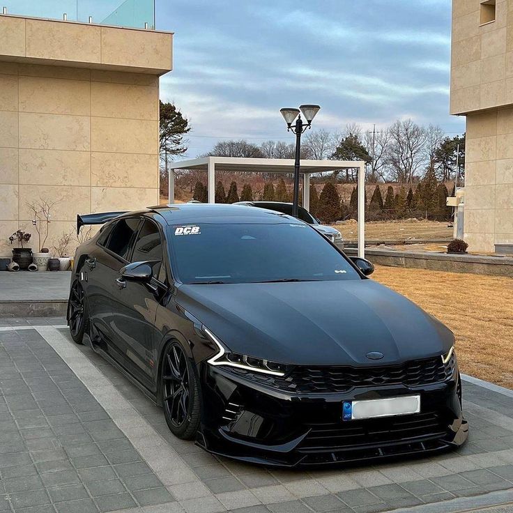 a black car parked in front of a building