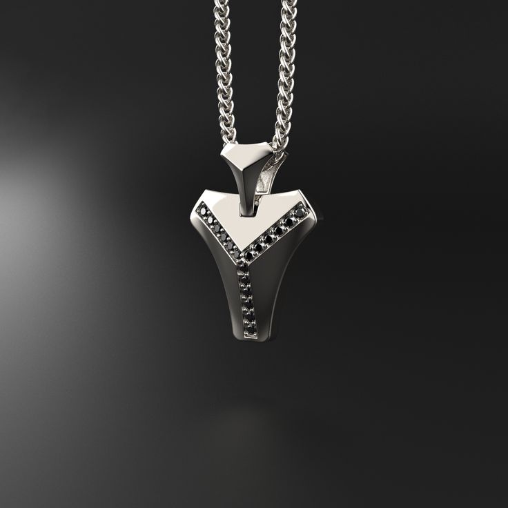 This magnificent pendant is composed of 18k white gold, includes 16 black diamonds and is completely handmade. A talisman stone is for those who want to know what life is all about. It will bring out all of your great qualities. The vertebrae that make up the human spine influenced its design. On a psychological level, this diamond represents what gives man the fortitude, bravery, drive, and unwavering belief to achieve his goals.Many people like white gold because of its silvery white hue, which gives it a refined appearance while also making it considerably more expensive than silver.White gold is impervious to rust, tarnish, and corrosion. White gold is more durable than yellow gold because it is alloyed with a combination of harder metals. Made entirely by hand with all the love and ar Silver Jewelry With Black Diamonds, Gift White Gold Jewelry With Black Spinel, Minimalist Silver Jewelry With Black Diamonds, White Gold Jewelry With Black Spinel For Gifts, Modern Black Diamond Jewelry, Minimalist Sterling Silver Jewelry With Black Diamonds, Modern Silver Jewelry With Black Diamonds, Modern Sterling Silver Jewelry With Black Diamonds, White Gold Black Spinel Jewelry For Gift