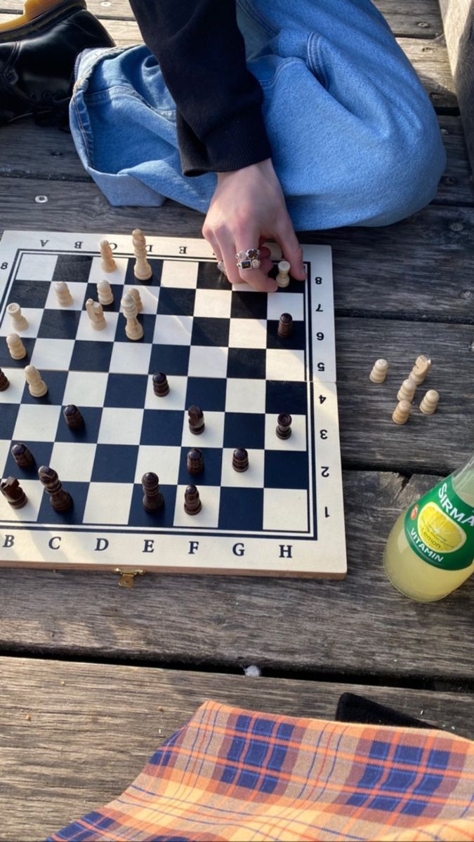 a person sitting on a bench playing chess