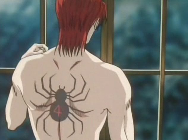 a man with red hair standing in front of a window looking at a spider on his back