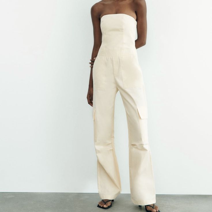 Cream Zara Long Cargo Jumpsuit Size / Medium Never Worn (New With Tags) Fitted High-waist Strapless Jumpsuit With Pockets, Fitted High Waist Strapless Jumpsuit With Pockets, Chic Strapless Jumpsuit With Pockets For Summer, Chic Strapless Summer Jumpsuit With Pockets, Summer Fitted Strapless Wide Leg Jumpsuit, Fitted Strapless Jumpsuit With Pockets For Summer, Fitted Strapless Jumpsuit With Pockets For Spring, Fitted High-waist Summer Pantsuit, Chic Fitted Jumpsuits And Rompers With Pockets